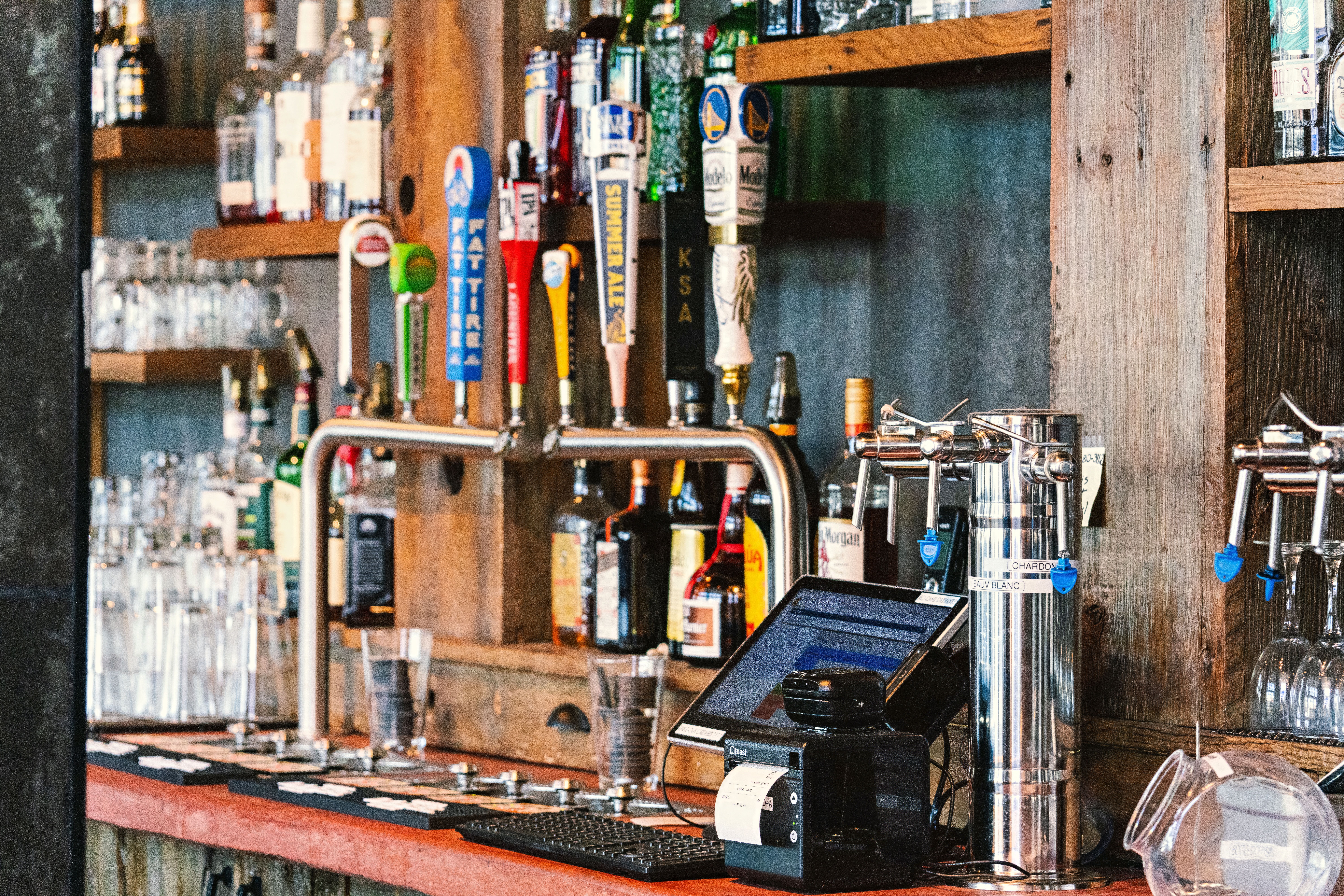 A%20charming%20bar%20setting%20with%20an%20array%20of%20craft%20beer%20taps%20and%20liquor%20bottles A charming bar setting with an array of craft beer taps and liquor bottles